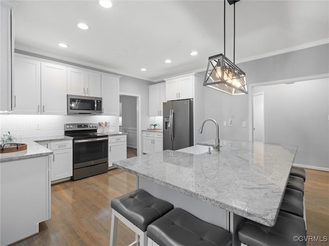 12306 Hollow Oak Ter, Midlothian, VA 23112 - kitchen featuring appliances with stainless steel finishes, ornamental molding, recessed lighting, tasteful backsplash, and light stone counters