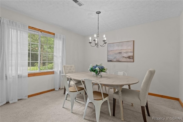 11192 Eventide Ln, Gloucester, VA 23061 - dining area featuring a chandelier, light colored carpet, and a textured ceiling