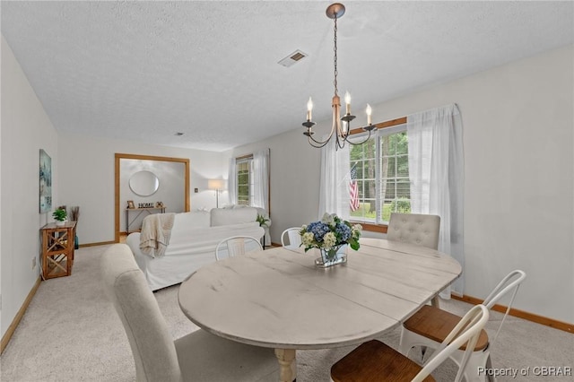 11192 Eventide Ln, Gloucester, VA 23061 - dining space with a textured ceiling, a chandelier, and light carpet