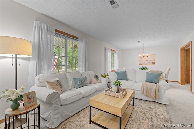 11192 Eventide Ln, Gloucester, VA 23061 - living room featuring a textured ceiling, a chandelier, and carpet flooring