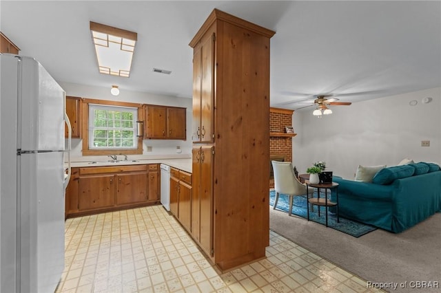 11192 Eventide Ln, Gloucester, VA 23061 - kitchen with white appliances, light flooring, a brick fireplace, light countertops, and open floor plan