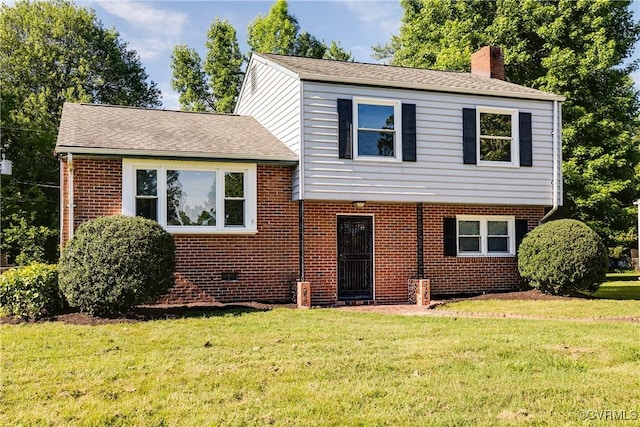 619 Winnetka Ave, Richmond, VA 23227 - split level home featuring a chimney, brick siding, and a front lawn