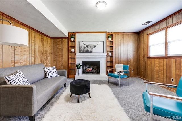 619 Winnetka Ave, Richmond, VA 23227 - living room with wood walls, carpet floors, a brick fireplace, and built in features