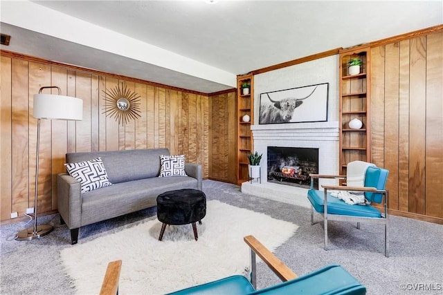 619 Winnetka Ave, Richmond, VA 23227 - carpeted living room featuring wood walls, a fireplace, and built in features