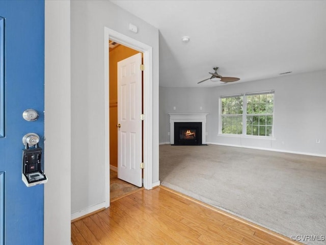 1624 Harvest Grove Ln, Henrico, VA 23223 - unfurnished living room featuring a ceiling fan, a fireplace with flush hearth, and wood finished floors