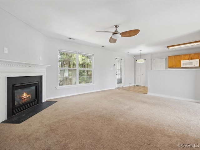 1624 Harvest Grove Ln, Henrico, VA 23223 - unfurnished living room featuring ceiling fan, light colored carpet, and a fireplace with flush hearth
