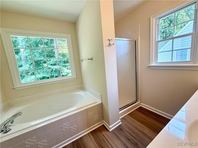 10342 Brickerton Dr, Mechanicsville, VA 23116 - bathroom with plenty of natural light, a garden tub, wood finished floors, and a stall shower