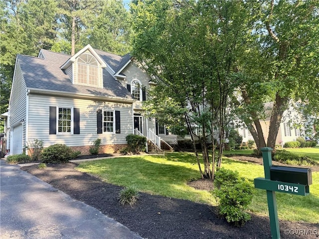 10342 Brickerton Dr, Mechanicsville, VA 23116 - view of front of house featuring a garage, a front lawn, asphalt driveway, and roof with shingles