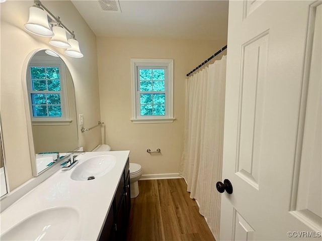 10342 Brickerton Dr, Mechanicsville, VA 23116 - bathroom featuring double vanity, wood finished floors, and a shower with shower curtain