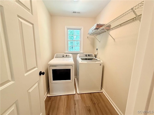 10342 Brickerton Dr, Mechanicsville, VA 23116 - laundry room with washer and dryer and wood finished floors