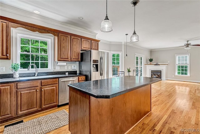16494 Connie Hall Rd, Montpelier, VA 23192 - kitchen with appliances with stainless steel finishes, light wood-style floors, a kitchen island, healthy amount of natural light, and crown molding