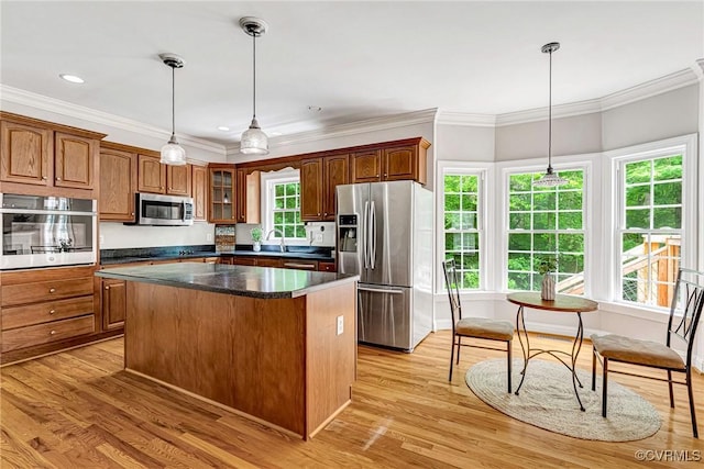 16494 Connie Hall Rd, Montpelier, VA 23192 - kitchen with stainless steel appliances, light wood-type flooring, crown molding, a center island, and dark countertops