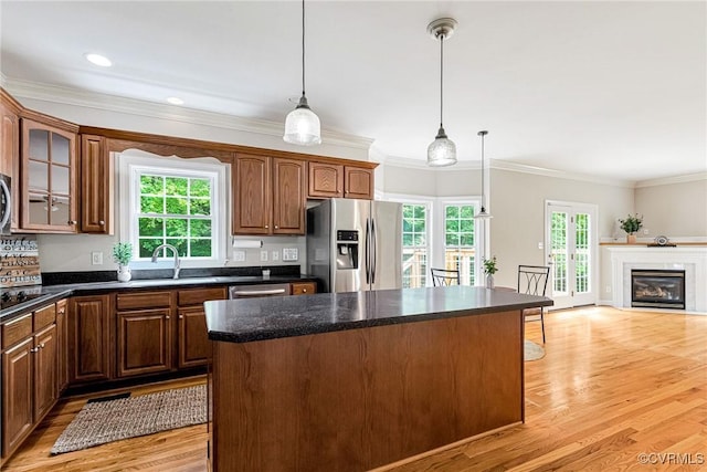 16494 Connie Hall Rd, Montpelier, VA 23192 - kitchen with appliances with stainless steel finishes, a center island, crown molding, light wood-type flooring, and decorative light fixtures