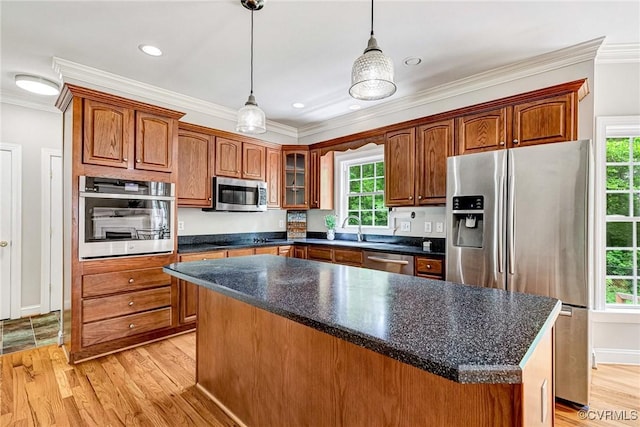 16494 Connie Hall Rd, Montpelier, VA 23192 - kitchen with appliances with stainless steel finishes, crown molding, light wood-style flooring, hanging light fixtures, and glass insert cabinets