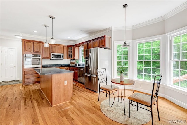 16494 Connie Hall Rd, Montpelier, VA 23192 - kitchen with appliances with stainless steel finishes, a kitchen island, healthy amount of natural light, crown molding, and dark countertops