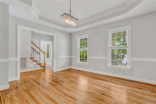 16494 Connie Hall Rd, Montpelier, VA 23192 - unfurnished room with a raised ceiling, crown molding, a chandelier, light wood-style floors, and stairs