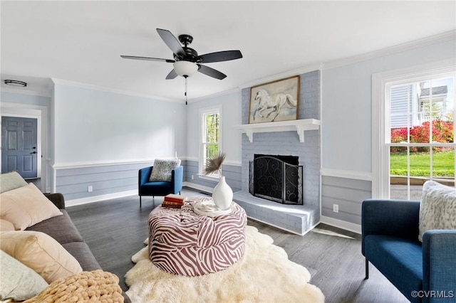 341 Rossmere Dr, Midlothian, VA 23114 - living room with crown molding, wood finished floors, ceiling fan, a fireplace, and a wainscoted wall