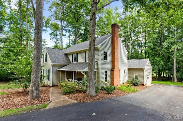341 Rossmere Dr, Midlothian, VA 23114 - view of front facade with roof with shingles, an outdoor structure, and a chimney