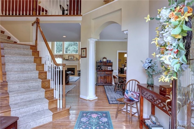 5669 Virginia Park Dr, Providence Forge, VA 23140 - foyer featuring decorative columns, stairway, arched walkways, wood finished floors, and a fireplace