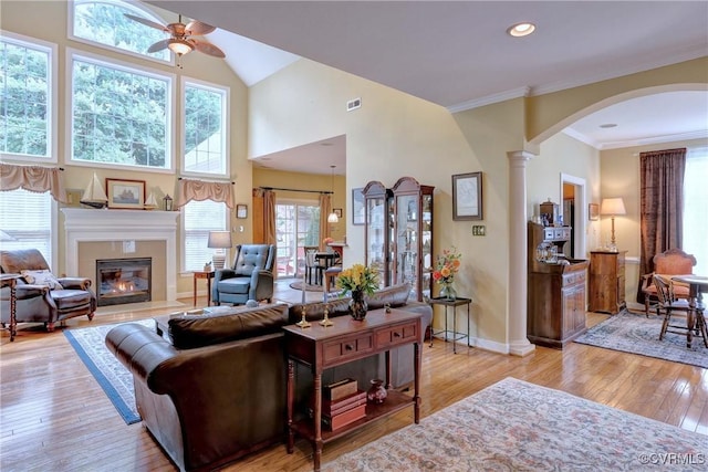 5669 Virginia Park Dr, Providence Forge, VA 23140 - living room featuring a ceiling fan, high vaulted ceiling, arched walkways, a tiled fireplace, and light wood-style floors