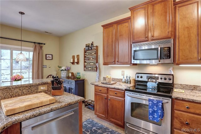 5669 Virginia Park Dr, Providence Forge, VA 23140 - kitchen with appliances with stainless steel finishes, brown cabinets, light stone counters, and hanging light fixtures