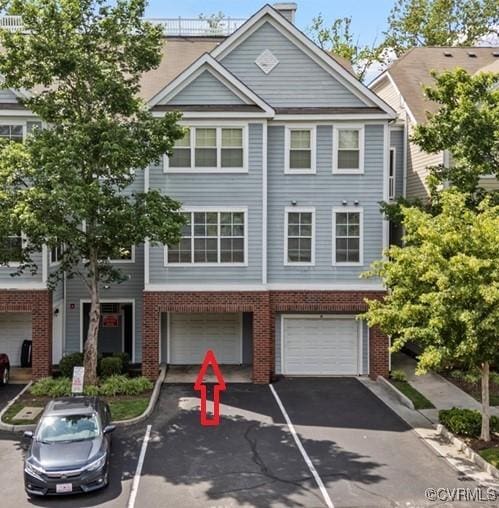 624 Bristol Village Dr Unit 302, Chesterfield, VA 23114 - view of property with driveway, a garage, and brick siding