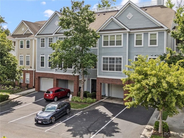 624 Bristol Village Dr Unit 302, Chesterfield, VA 23114 - townhome / multi-family property featuring a garage, brick siding, and driveway