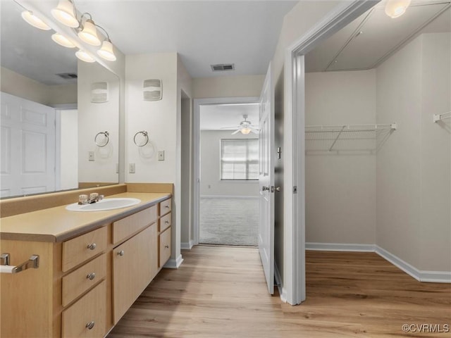 624 Bristol Village Dr Unit 302, Chesterfield, VA 23114 - bathroom with vanity, wood finished floors, a ceiling fan, and a walk in closet