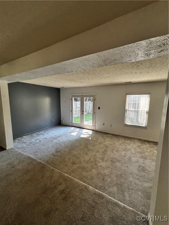 1811 Random Winds Ct, Henrico, VA 23238 - empty room with carpet flooring, french doors, and a textured ceiling
