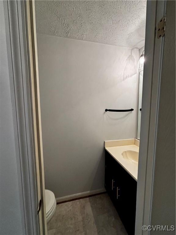 1811 Random Winds Ct, Henrico, VA 23238 - bathroom featuring vanity and a textured ceiling