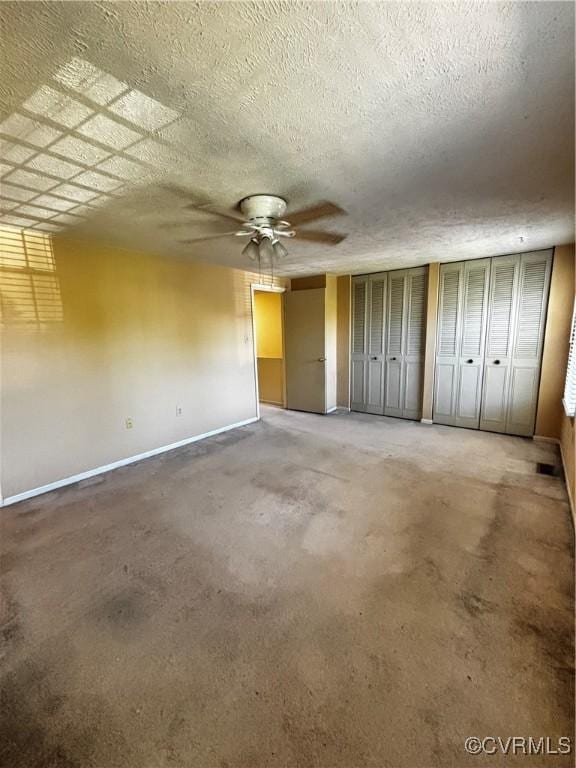 1811 Random Winds Ct, Henrico, VA 23238 - unfurnished bedroom with a ceiling fan, carpet flooring, a textured ceiling, and multiple closets