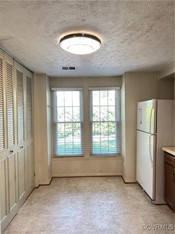 1811 Random Winds Ct, Henrico, VA 23238 - unfurnished dining area with a textured ceiling and light floors
