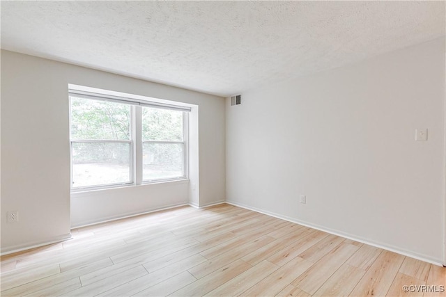 8404 Muldoon Ct Unit 4, Henrico, VA 23228 - unfurnished room with light wood finished floors and a textured ceiling