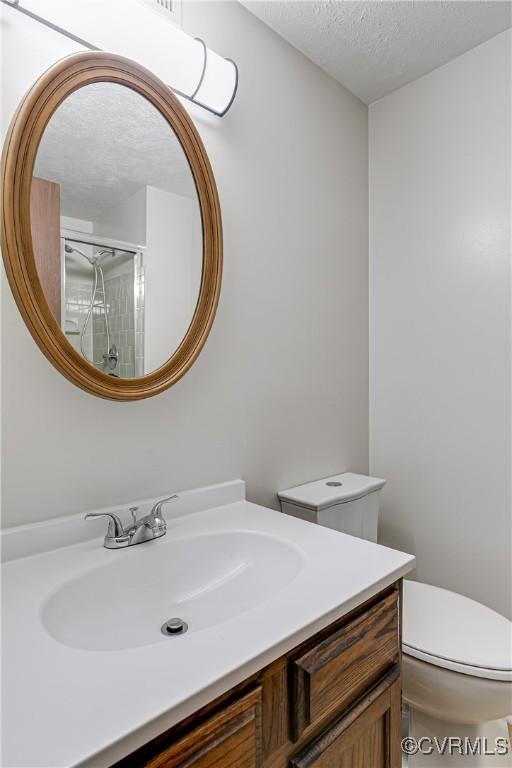 8404 Muldoon Ct Unit 4, Henrico, VA 23228 - bathroom featuring vanity, a textured ceiling, and a shower with shower door