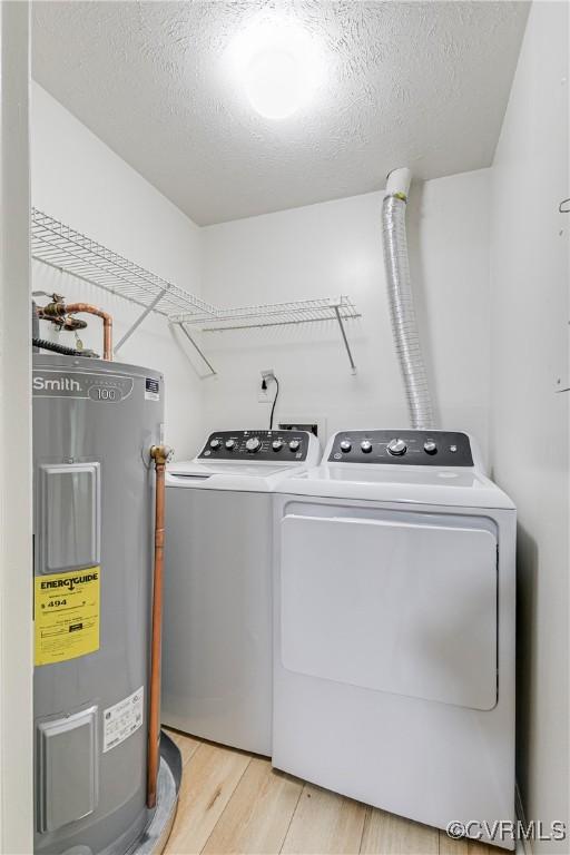 8404 Muldoon Ct Unit 4, Henrico, VA 23228 - laundry room with electric water heater, washing machine and clothes dryer, light wood-style flooring, and a textured ceiling