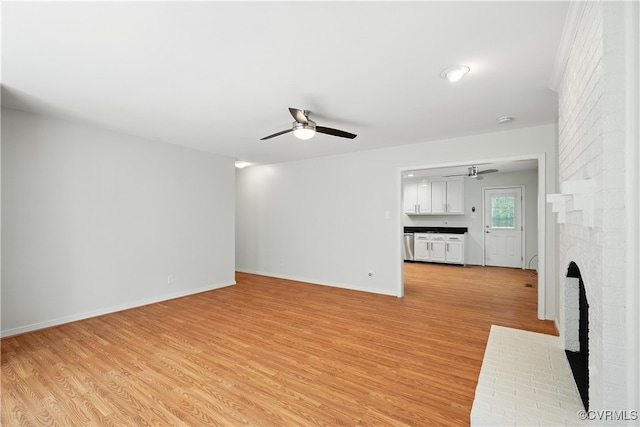 15685 Kennons Ln, Amelia, VA 23002 - unfurnished living room featuring a fireplace, ceiling fan, and light wood-style flooring
