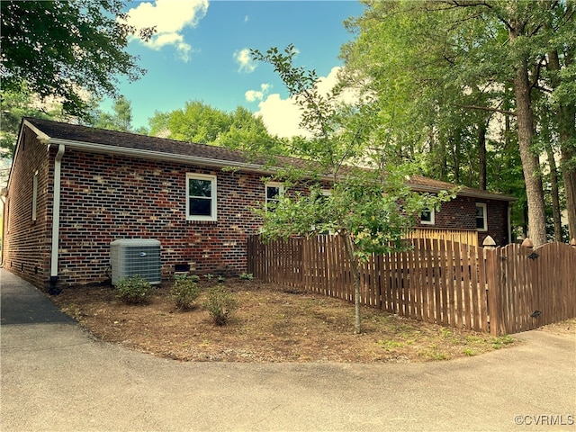 12027 Old Buckingham Rd, Midlothian, VA 23113 - view of property exterior featuring a central AC unit and brick siding