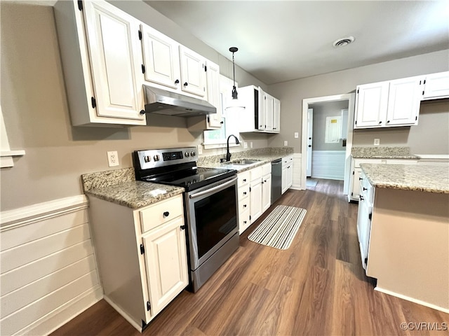 12027 Old Buckingham Rd, Midlothian, VA 23113 - kitchen featuring appliances with stainless steel finishes, under cabinet range hood, dark wood-style flooring, light stone counters, and wainscoting