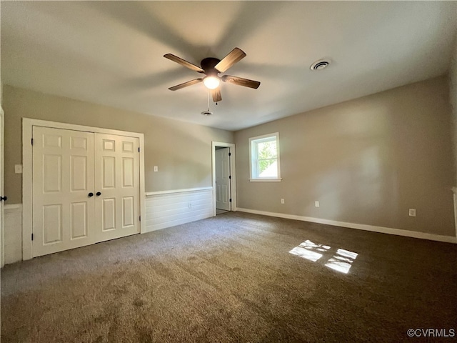 12027 Old Buckingham Rd, Midlothian, VA 23113 - unfurnished bedroom with carpet floors, a wainscoted wall, a closet, and a ceiling fan