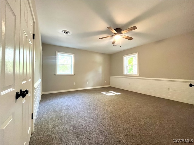 12027 Old Buckingham Rd, Midlothian, VA 23113 - empty room with dark colored carpet, plenty of natural light, and ceiling fan