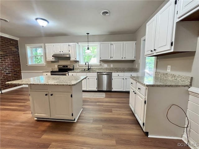12027 Old Buckingham Rd, Midlothian, VA 23113 - kitchen featuring stainless steel appliances, white cabinetry, under cabinet range hood, healthy amount of natural light, and brick wall