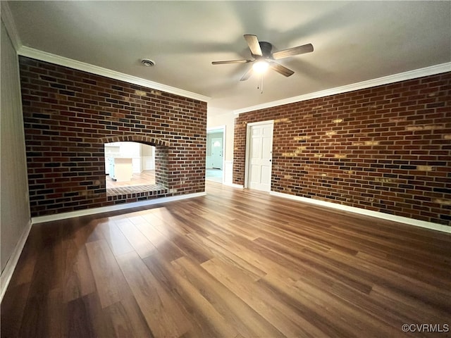12027 Old Buckingham Rd, Midlothian, VA 23113 - unfurnished living room with wood finished floors, ceiling fan, brick wall, crown molding, and a multi sided fireplace