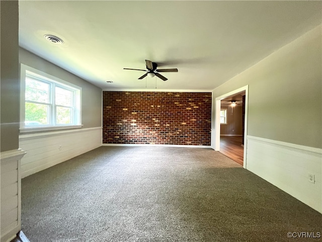 12027 Old Buckingham Rd, Midlothian, VA 23113 - carpeted empty room featuring a ceiling fan, a wainscoted wall, and brick wall