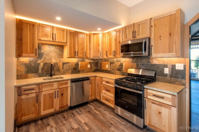 2921 E Marshall St, Richmond, VA 23223 - kitchen with stainless steel appliances, light brown cabinetry, dark wood-type flooring, tasteful backsplash, and recessed lighting