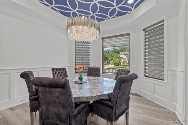 12313 Haybrook Ln, Henrico, VA 23059 - dining area with a decorative wall, light wood-style floors, a chandelier, wainscoting, and a tray ceiling