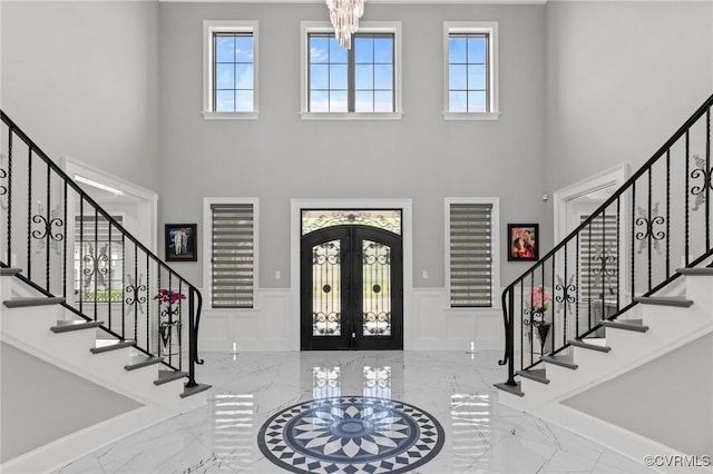 12313 Haybrook Ln, Henrico, VA 23059 - entrance foyer featuring marble tiled flooring, a high ceiling, french doors, plenty of natural light, and a wainscoted wall