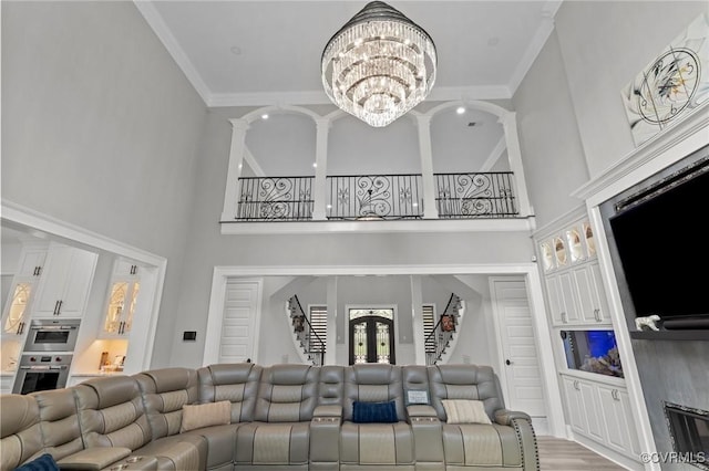 12313 Haybrook Ln, Henrico, VA 23059 - living room featuring a chandelier, a high ceiling, crown molding, and wood finished floors