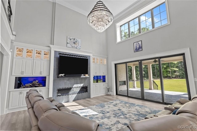 12313 Haybrook Ln, Henrico, VA 23059 - living area featuring a towering ceiling, wood finished floors, french doors, a glass covered fireplace, and plenty of natural light