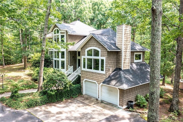 4604 Chesdin Woods Dr, Sutherland, Sutherland, VA 23885 - shingle-style home with a shingled roof, a chimney, driveway, and an attached garage