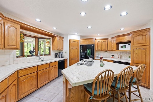 4604 Chesdin Woods Dr, Sutherland, Sutherland, VA 23885 - kitchen featuring black appliances, a kitchen breakfast bar, backsplash, recessed lighting, and light tile patterned flooring